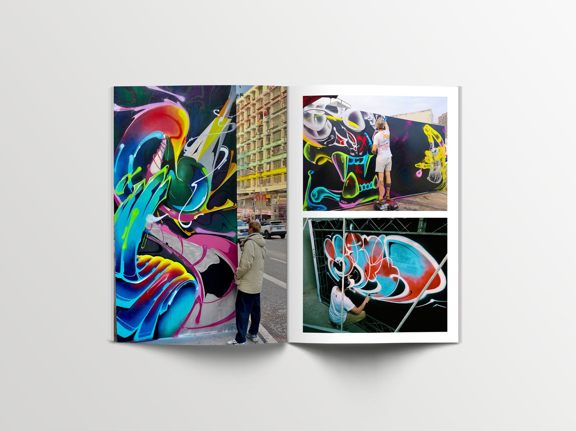 Open magazine showcasing vibrant street art murals with graffiti artists at work in an urban setting.