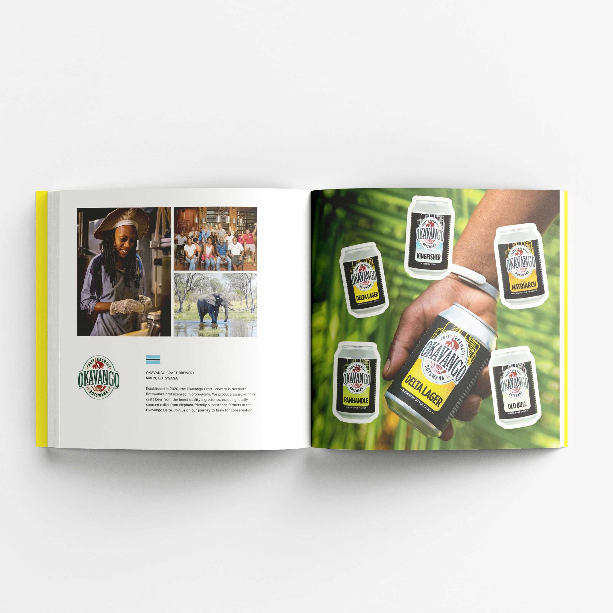 An open book displaying a two-page spread. The left page features the logo of Okavango Craft Brewery from Botswana, along with three photos: a brewer at work, a group of people posing together, and an elephant in a river. The text provides information about the brewery. The right page showcases various Okavango Craft Brewery beer cans with labels for different styles such as Delta Lager, Kingfisher, and Namibian Pale Ale. The background shows a hand holding a can of Delta Lager with green foliage behind.