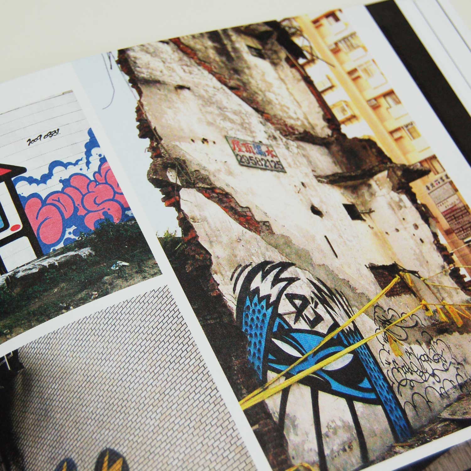 Open book from 'Graffiti Asia' showing a page with multiple photos of graffiti. The images include colorful graffiti art on various surfaces, including a dilapidated building and walls with different graffiti styles and designs including the work of 'Reach' from Taiwan.